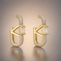 Gold pave oval hoop earrings with baguette V detail