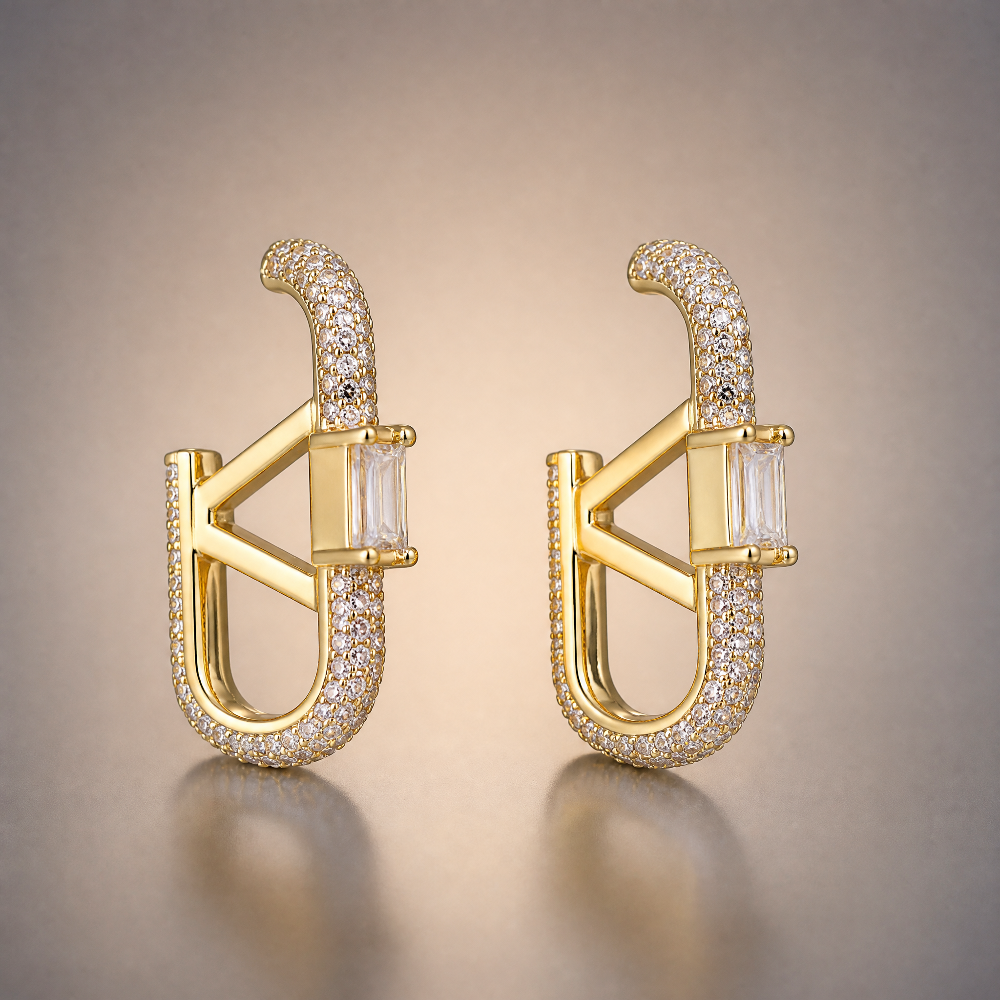 Gold pave oval hoop earrings with baguette V detail