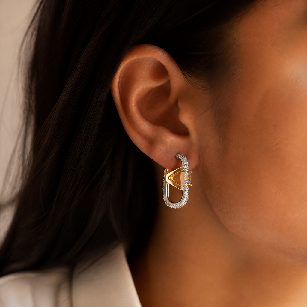 Gold pave oval hoop earrings with baguette V detail