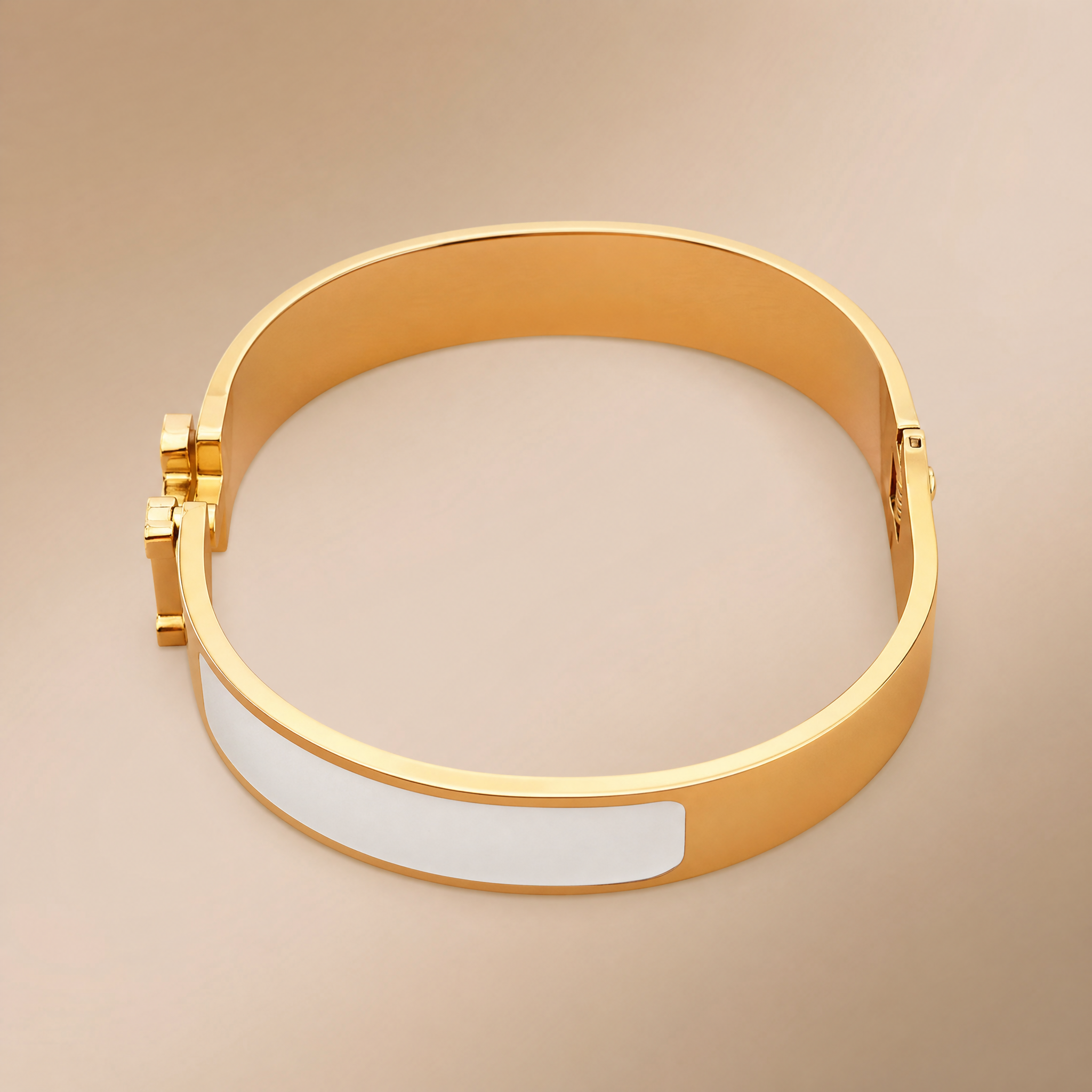 Gold hinged bangle with white enamel inlay