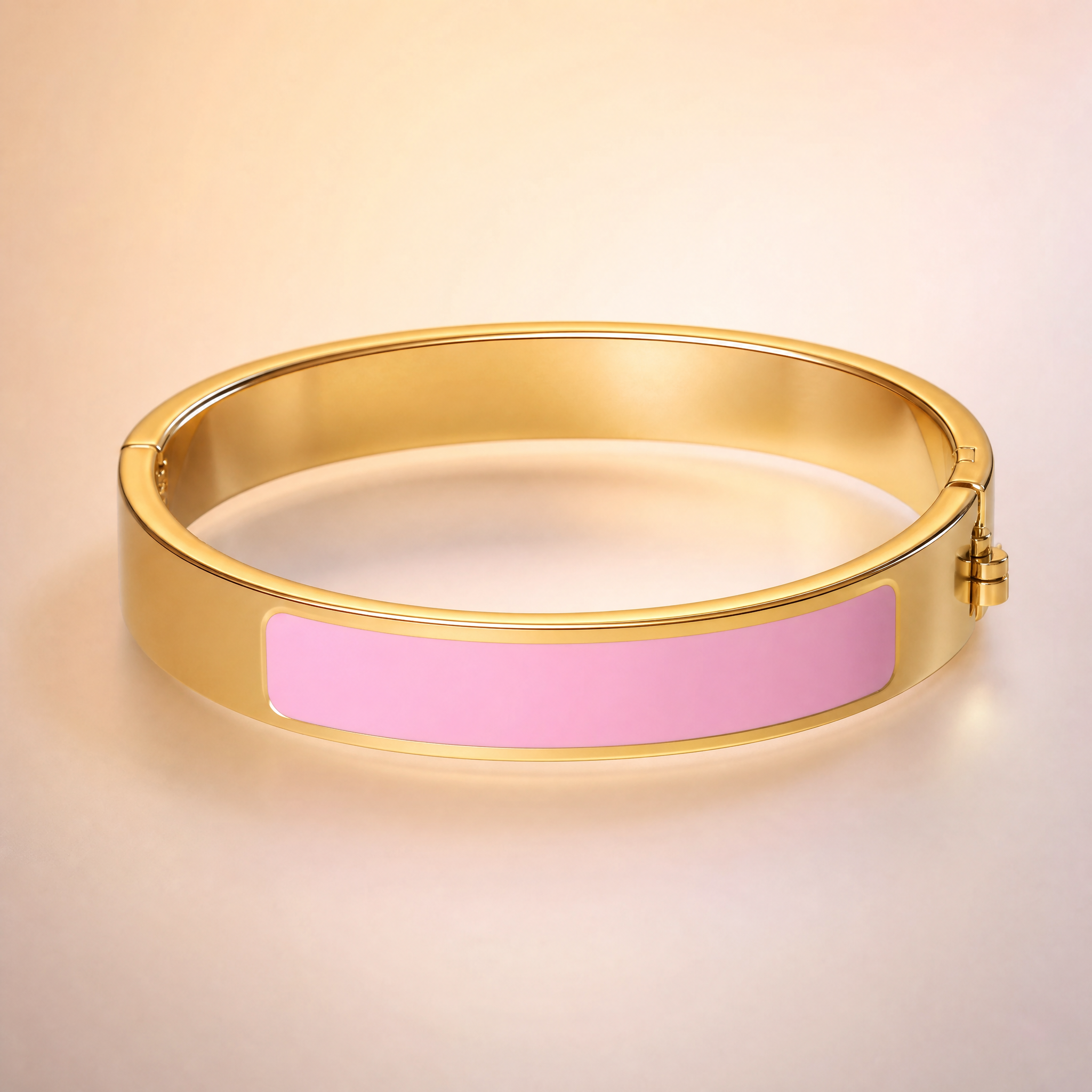 Gold hinged bangle with pink enamel inlay