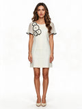 Cream shift dress with black circle applique and ruffle sleeves