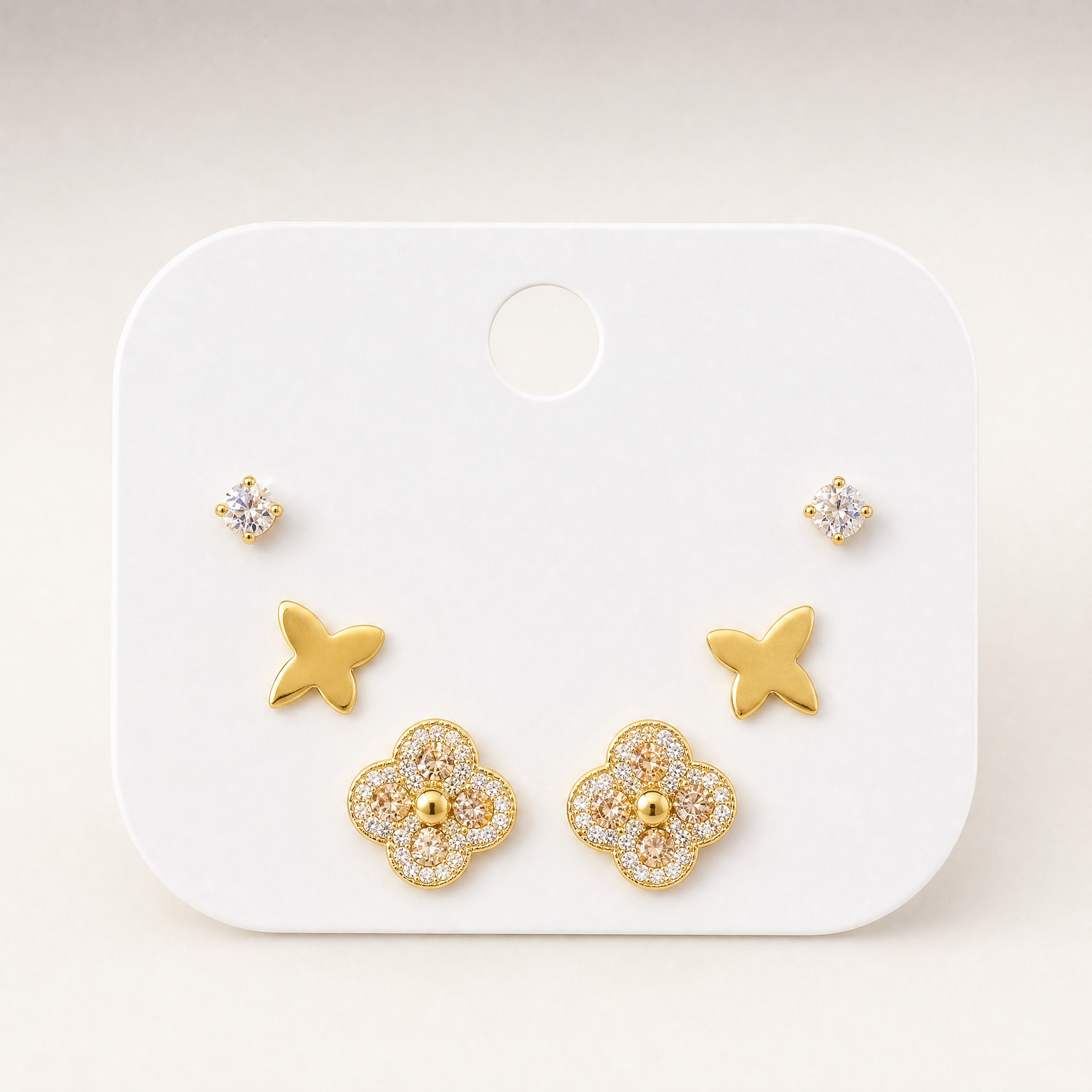 Gold tone 3-pair stud earring set with crystal, butterfly & clover studs