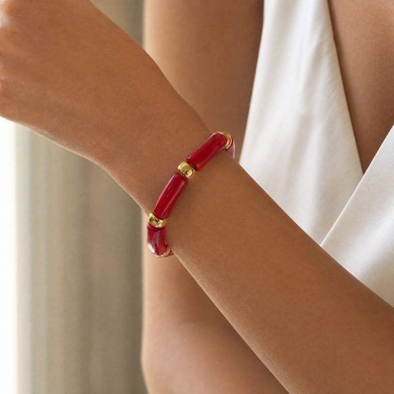 Red-marble curved-tube stretch bracelet, gold spacers