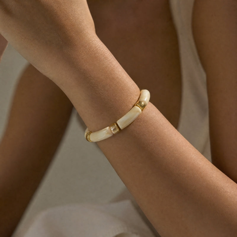 Cream-marble curved-tube stretch bracelet, gold spacers