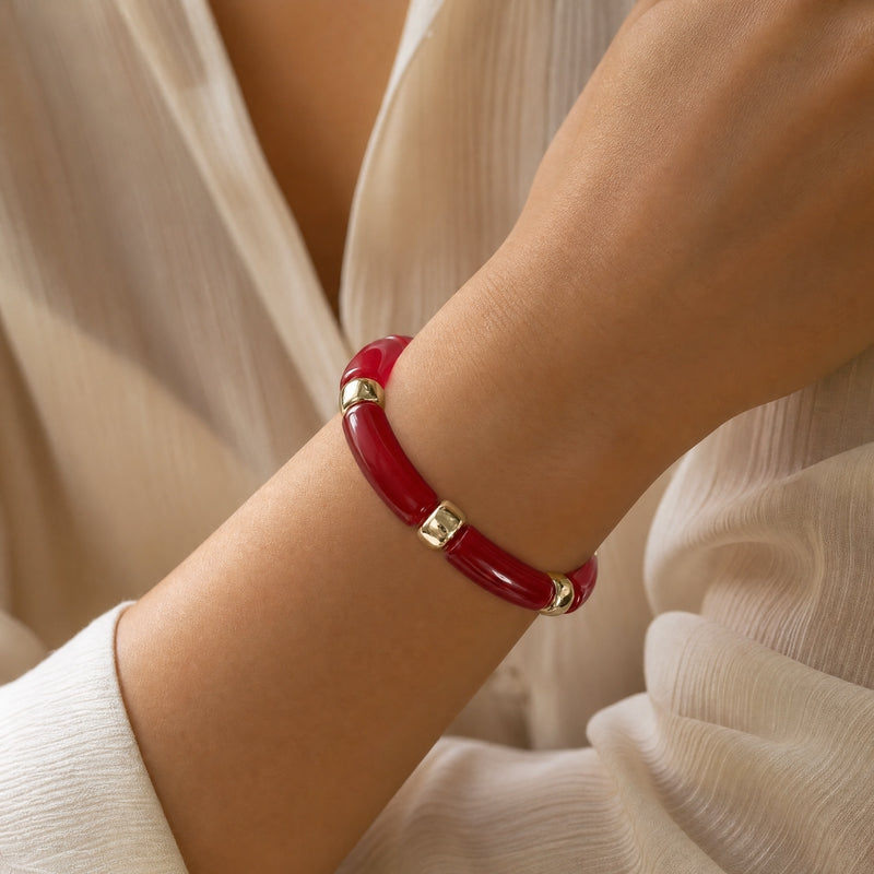 Deep-red curved-tube stretch bracelet, gold spacers