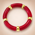 Deep-red curved-tube stretch bracelet, gold spacers