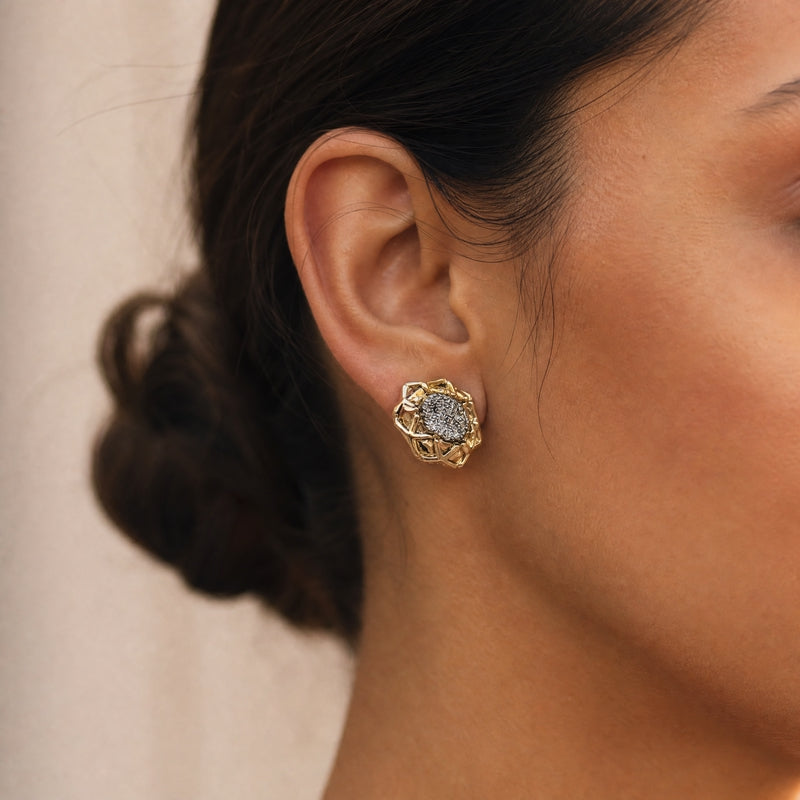Gold openwork flower-frame studs, black CZ pavé centre
