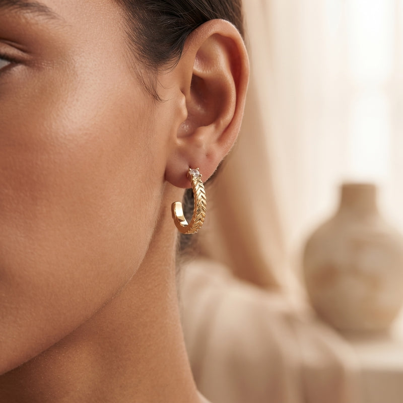 Gold laurel-braid C-hoop huggies with CZ accent