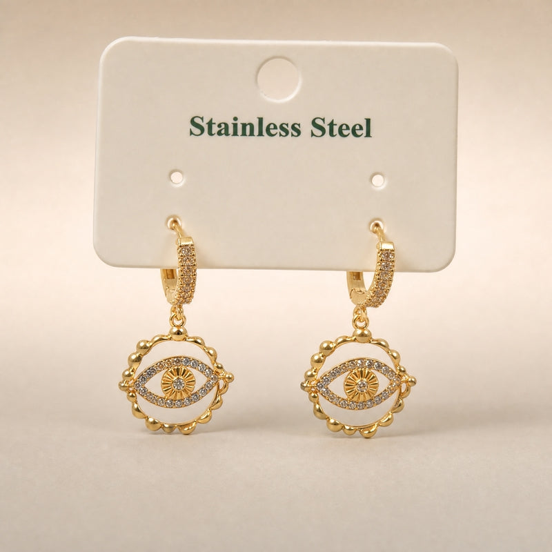 Gold huggie drops, CZ evil-eye charm, scalloped frame