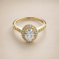 Gold halo ring, oval CZ centre, pavé halo & shoulders