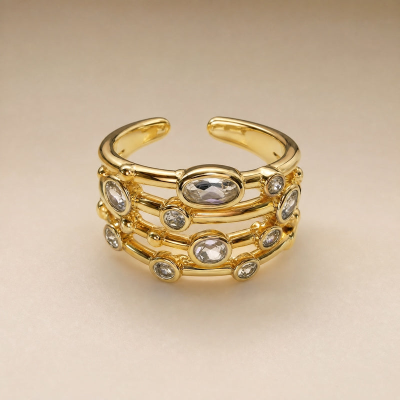 Gold open multi-row ring, scattered bezel-set CZs