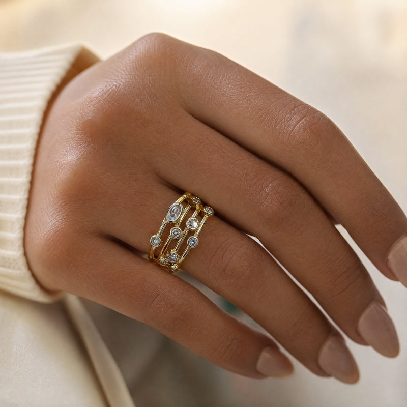 Gold open multi-row ring, scattered bezel-set CZs