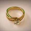 Gold crossover ring, round CZ solitaire, pavé split band